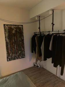 a room with racks of clothes hanging on a wall at Lake view, private balcony in Skanderborg
