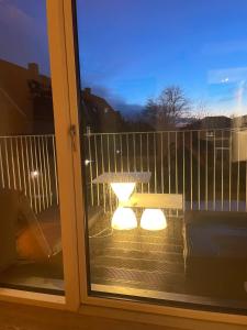 a window with a table and a bench on a balcony at Lake view, private balcony in Skanderborg