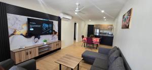 a living room with a couch and a flat screen tv at The Retreat Apartment in Nadi