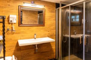 a bathroom with a sink and a shower and a mirror at The Cottage - Assure your Tickets for the Ella train journey in Ambawela +155 photos
