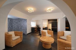 a living room with chairs and a table at Don Leon Boutique in Even Menahem