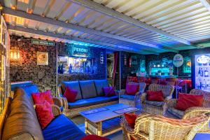 a bar with couches and chairs in a room at Exclusive SUPER-SIZE Holiday home - 12 bed,11 bath with Amazing Facilities, Sea and Mountain Views in Tías