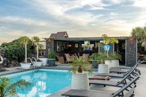a swimming pool with lounge chairs next to a house at Exclusive SUPER-SIZE Holiday home - 12 bed,11 bath with Amazing Facilities, Sea and Mountain Views in Tías