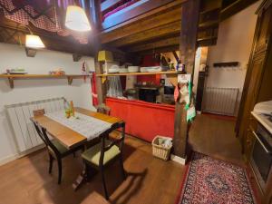 an overhead view of a kitchen with a dining room table at CasaVacanze Roccaraso in Roccaraso +16 photos