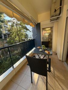 a balcony with a table and chairs and a window at The Allatini project Thessaloniki- Part of P STAYS COLLECTION in Thessaloniki +16 photos