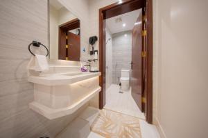 a bathroom with a sink and a toilet at Revana for families in Jeddah +39 photos