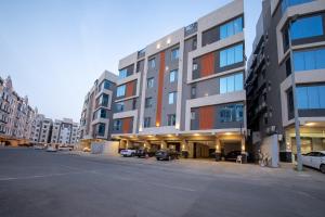 an empty parking lot in front of a large building at Revana for families in Jeddah