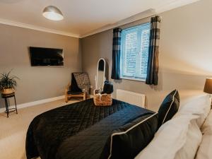 a bedroom with a large bed and a window at 5 Mariners Wharf in Newhaven
