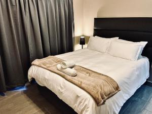 a bedroom with a large bed with a black headboard at 16 on Les De Jager in Pietermaritzburg