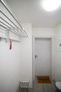 a hallway with a white door and a rug at Za radnicí 2 & 5 by Mountain ways in Rokytnice nad Jizerou