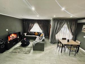 a living room with a couch and a table at 16 on Les De Jager in Pietermaritzburg