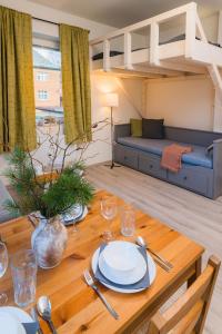 a living room with a table and a loft bed at Za radnicí 2 & 5 by Mountain ways in Rokytnice nad Jizerou +25 photos