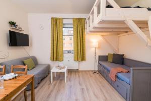 a living room with a couch and a loft at Za radnicí 2 & 5 by Mountain ways in Rokytnice nad Jizerou