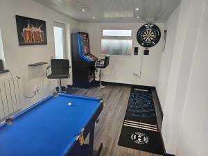a play room with a pool table and a dartboard at 58 Clifton Rise in Abergele