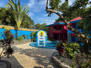 a pool in front of a house at Hotel Carmen Costa Coral in Tambor