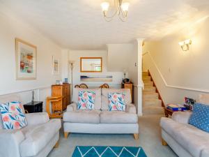 a living room with two couches and a bed at River View in Wadebridge