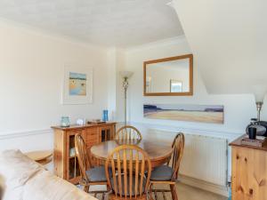 a dining room with a table and chairs and a couch at River View in Wadebridge