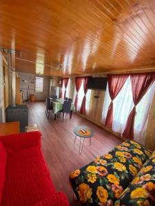 a living room with a couch and a table at Cabañas Mocopulli in Dalcahue