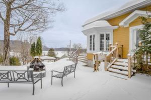 ein Haus mit Schnee auf der Veranda in der Unterkunft Spa Lake - Naturo lac Sept-Iles in Saint-Raymond + 39 Fotos