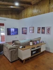 a living room with a couch and a table at Lugar Acolhedor e Próximo a Natureza in Florianópolis