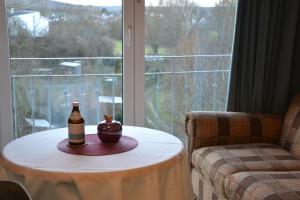 a table with an apple on it next to a window at Christian Gartenhotel in Nieder-Olm