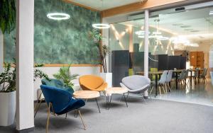 a group of chairs and tables in a room at Hotel Riviera in Mierzyn