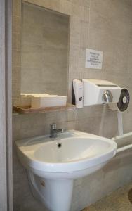 a bathroom with a white sink and a mirror at Hotel Riviera in Mierzyn +56 photos