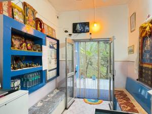a bathroom with a shower with a glass door at Tara Guest House in Bodh Gaya