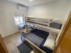 a small room with two bunk beds in it at Piso en Calle Albares De La Ribera in Madrid