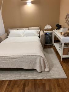 a bedroom with a white bed and a table at AGAVE Suite in Lecce