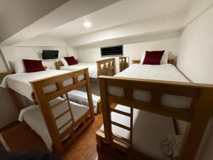 a group of three bunk beds in a room at Ayenda Marana in Manizales +56 photos