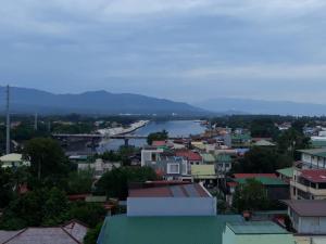 a view of a city with a river and buildings at Domizil Suites in Batangas City