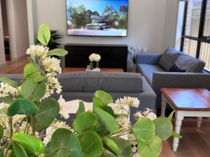 a living room with a couch and a table at Seas the Day - Bay Stay in Tootgarook