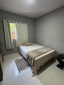 En eller flere senge i et værelse på Sítio Mirante da Mata