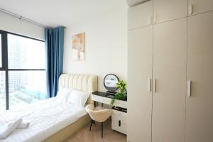 a white bedroom with a bed and a window at Tommy Land in Gò Công +33 photos