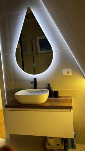a bathroom with a sink and a mirror at Air Cabin A2, A-frame Șerani, Bihor in Şerani +17 photos
