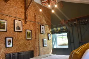 a bedroom with a wall with pictures on it at Ty Llaeth in Llanstephan