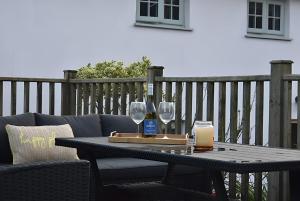 a table with two wine glasses and a candle at Ty Llaeth in Llanstephan