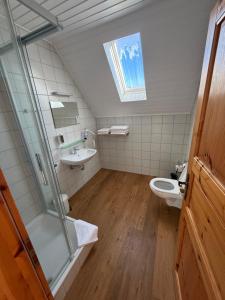 a bathroom with a toilet and a sink at Zum Kaiserwirt in Heppenheim an der Bergstrasse +58 photos