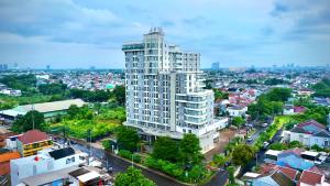 an overhead view of a tall white building in a city at Escotel Amazana in Cileduk 1