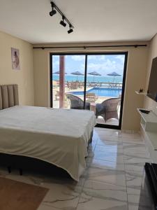 a bedroom with a bed and a view of the ocean at Pousada Porto Meu Amor in Porto De Galinhas +90 photos