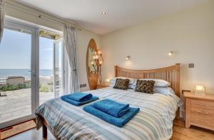 a bedroom with a bed with a view of the ocean at 3 Bed in Croyde oc-spind in Croyde
