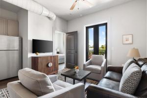 a living room with a couch and a table at Fire Tower Luxe 2BR KingSuites & Private Balcony in Charleston