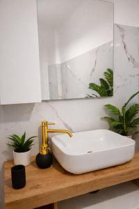 a bathroom with a white sink and a mirror at Nuvola Luxury suite con Idromassaggio Privato & Relax romantico in Turin