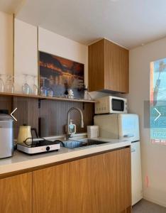 a kitchen with a sink and a refrigerator at 인천청라점 이상한스테이 