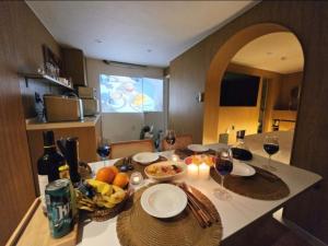 a table with glasses of wine and fruit on it at 인천청라점 이상한스테이 