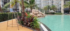 a chair sitting next to a swimming pool in a building at Tommy Land in Gò Công