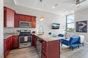 a kitchen with wooden cabinets and a stove top oven at Magnificent 1BR with Pool & Gym in Philadelphia