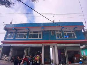 a building with people standing outside of it at Tashidelk homestay in Darjeeling