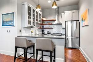 a kitchen with two chairs and a refrigerator at Perfect Location - King Street Condo in Charleston